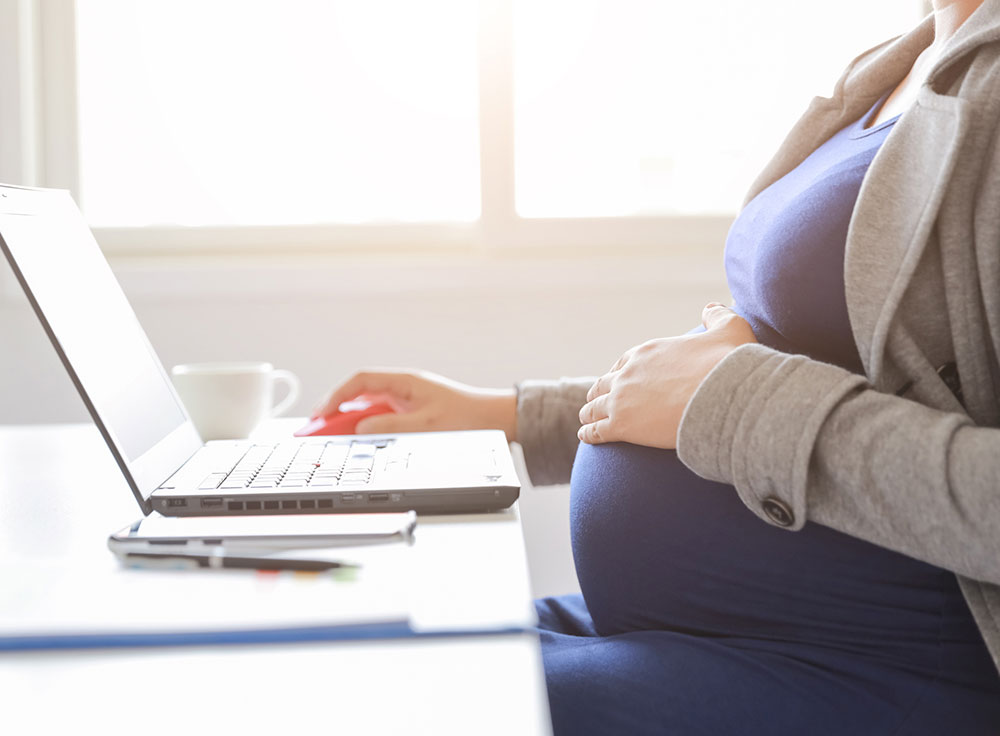Photo of pregnant woman at a computer
